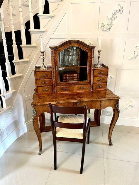 Outstanding quality antique Victorian burr walnut Bonheur de Jour writing desk having a beautifully designed and shaped top glazed cabinet to the centre which opens to reveal a fitted mirror and shelf interior with elegant ormolu mounts to the sides, one long burr walnut drawer below with attractive tulipwood crossbanding and flanked by tulipwood crossbanded burr walnut drawers with pretty original brass gilded handles and galleries. The base boasts a magnificent burr walnut inlaid shaped top wi 1890s Decor, Colonial Desk, Victorian Desk, Vintage Desks, Walnut Mirror, Desk Cabinet, Pedestal Desk, Dream Furniture, Indie Room Decor