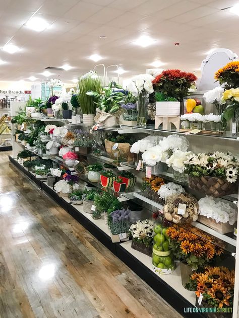 Many faux flowers and vases for sale on a store shelf. Faux Flower Boxes, Fake Flowers In Planters, Porch Decorating With Faux Plants, Front Porch Ideas Faux Plants, Best Silk Flowers, Flower Arrangements In Pitchers, Faux Planter Fillers, Artificial Flower Pots Outdoor, Artificial Flowers For Outdoor Planters