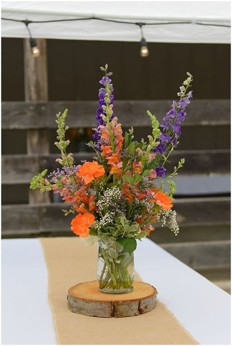 Orange and purple floral rustic wedding centerpieces Orange Wedding Centerpieces, Orange Purple Wedding, Floral Rustic Wedding, Cheap Wedding Table Centerpieces, Orange Centerpieces, Beautiful Wedding Centerpiece, Expensive Flowers, Rustic Centerpiece, Wedding Motifs