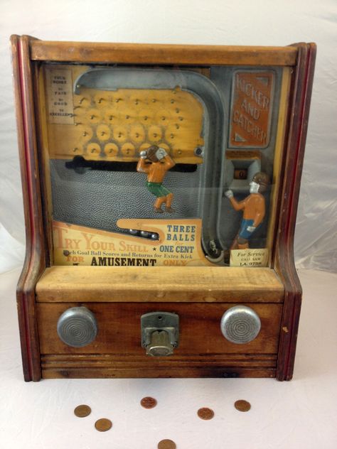 Fabulous 1930s Coin-Operated Penny Arcade Kicker and Catcher Football Game    Behind the glass front panel, a colorful metal kicker and catcher, clad in vintage 1930s football attire are just waiting for the penny to drop. A penny releases three metal balls to the kicker, who then punts them one by one in the direction of the catcher. Before reaching the catcher, each ball must travel through a maze of metal pegs. Slot Machine Tattoo, Game Cabinet, Coin Op Machine, Vintage Slot Machines, Diy Video Game, Vintage Arcade, Arcade Game Machines, Penny Arcade, Machine Tattoo