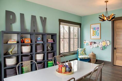 Contemporary playroom features walls painted green fitted with a dark gray framed window next to ... Homework Room, Modern Kids Furniture, Large Wooden Letters, Grey Shelves, Basement Playroom, Recreational Room, Office Playroom, Kids' Playroom, Toy Rooms