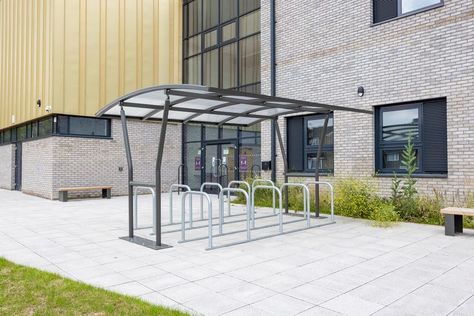 The Malford cycle shelter MCS204 is a double sided modular steel frame cycle shelter unit that works on a multiple bay system and can be loaded from both sides. The larger canopy of this shelter means two rows of cycle racks can be installed beneath it for a greater cycle spaces per shelter ratio, with 16-20 cycles parked per bay (BREEAM Standard dependent). Extension bays can be added until you reach the desired amount of parking spaces. Cycle Shelters, Community Centre, Street Furniture, Garden Arch, Steel Frame, Gazebo, Double Sided, Room Divider, Siding