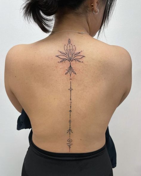 A delicate and intricate spine tattoo featuring a lotus flower design at the top with geometric and ornamental elements extending down the back Meaningful Spine Tattoos, Meaningful Spine Tattoos For Women, Back Tattoo For Women, Spinal Tattoo, Floral Back Tattoos, 70s Makeup, Spine Tattoos For Women, Spine Tattoo, Back Tattoo Women