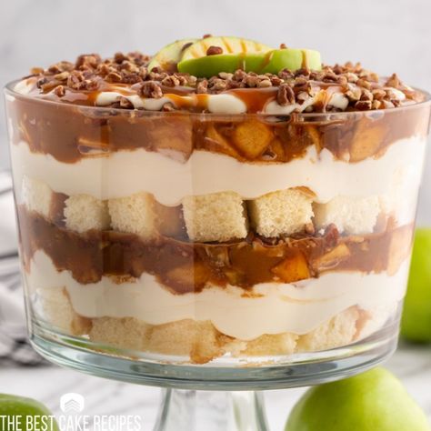 This Caramel Apple Cheesecake Trifle has layers of pound cake, fried apples, cheesecake filling, caramel and pecans. This is a gorgeous layered dessert for fall parties. Fall Triffle Desserts, Apple Trifle Desserts, Fall Dessert Trifles, Fall Trifle, Spice Cake Trifle Desserts, Easy Fall Trifle Desserts, Thanksgiving Trifle, Fall Trifle Desserts, Apple Trifle Desserts Fall