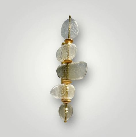 Illuminate your space with exquisite craftsmanship and artistic flair through our Handcrafted Blown Glass Stone Wall Sconce. This stunning lighting fixture is meticulously crafted by skilled artisans, combining the elegance of blown glass with the rustic charm of textured stone. Perfect for enhancing the ambiance of bedrooms and bathrooms, its modern artisan design adds a touch of sophistication to any interior decor. Whether casting a soft glow for relaxation or providing functional lighting, this vintage-inspired wall lamp is sure to captivate attention and elevate the aesthetic appeal of your living space. Experience the fusion of timeless elegance and contemporary style with our Handcrafted Blown Glass Stone Wall Sconce Glass Applique, Stone Fireplace Wall, Glass Bottle With Stopper, Wall Lamp Design, Light Bathroom, Wall Sconces Bedroom, Bathroom Light, Modern Wall Sconces, Elegant Bedroom