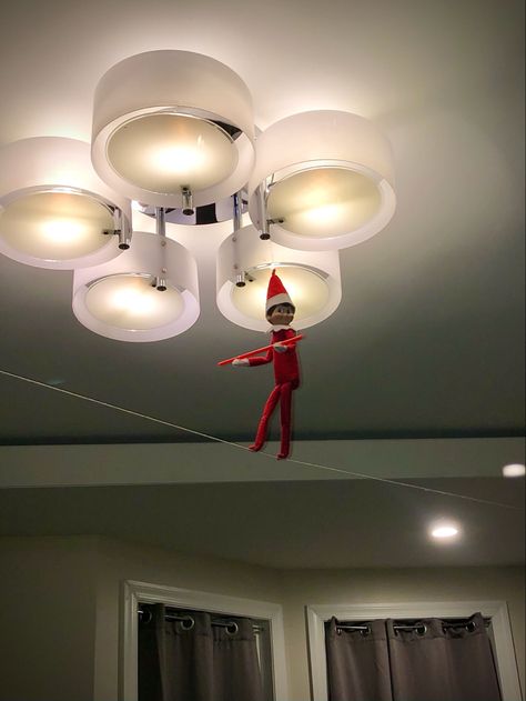 2021 Day 11: Cocoa the Scout Elf precariously balances as he takes a daring walk along the high wire Elf 2023, The Scout, On The Shelf, The Elf, The High, Elf On The Shelf, Cocoa, Elf, Ceiling