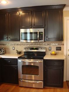 Painted and Glazed Kitchen Cabinets - Painted cabinets with a dark glazed finish completed this kitchen remodel. It feels so much warmer and elegant now. Hard t… Glazed Kitchen Cabinets, Kitchen Cabinets Painted, Cabinets Painted, Paint Kitchen, New Kitchen Cabinets, Dark Kitchen Cabinets, Kitchen Decorating, Black Cabinets, Kitchen Redo