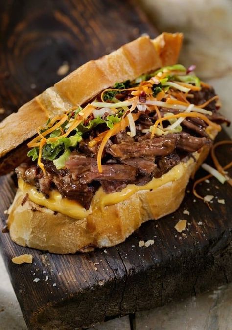 Globally inspired, this warm dinner-sandwich, reminiscent of Vietnamese Banh Mi, has been adapted from a recipe developed by Mexican Chef Josefina Santacruz. Short Rib Sandwich Recipe, Braised Beef Sandwich, Short Rib Sandwich, Veggies Roasted, Vietnamese Banh Mi, Garlic Mayonnaise, Rib Sandwich, Dinner Sandwich, Steak Sandwiches