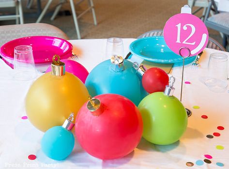 DIY Christmas Table Decor Ideas. Christmas Balloon Tablescape that looks like big ornaments. Great cheap centerpiece for your Christmas party. Fun idea for a kids table or a big event. Easy DIY Christmas ornaments w. balloons. FREE template & SVG included to make ornament toppers. BE creative, cheer up your holiday table settings w. multi colored plates and balloons in non-traditional colors. Golds, reds, hot pink, bright blue, & light green. #christmas #tablescape #balloons Press Print Party! Centerpiece Christmas Diy, Christmas Party Decorations Table, Christmas Diy Ornaments, Balloon Centerpieces Diy, Holiday Party Centerpieces, Christmas Party Centerpieces, Party Centerpieces Diy, Cheap Centerpieces, Christmas Centerpieces Cheap