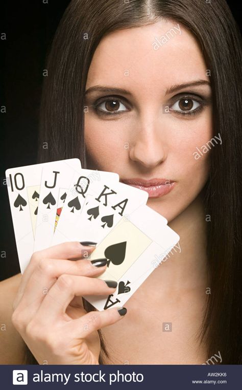 Woman holding playing cards Stock Photo Hand Holding Deck Of Cards Drawing, Shuffling Cards Pose Reference, Person Holding Cards Reference, Card Holding Pose, Joker Holding Card, Holding Cards Pose Reference, Holding Cards Reference, Hands Holding Cards, Hand Holding Playing Cards