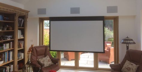 Projector Screen Over Window, Family Room With Projector Screen, Projector Screen In Front Of Window, Living Room Projector Screen, Rooms With Projector Screen, Pull Down Projector Screen Living Room, Hide A Projector, Recessed Projector Screen, Projection Screen Living Room