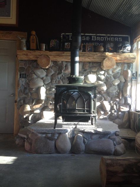 River Rock Hearth Wood Stoves, River Rock Wood Stove Surround, Stone Hearth For Wood Stove, Stone Hearth Wood Stove, Rock Wall Behind Wood Stove, Wood Stove With Mantle, Diy Stone Wall Interior, Pellet Stove Hearth, Diy Stone Wall