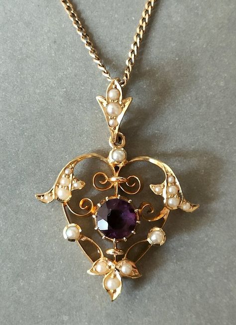 Beautiful Victorian 15ct Gold Amethyst Heart Pendant. This superb quality Pendant has a beautiful coloured amethyst measuring 6mm x 6mm. It is a really pretty design set with natural seed pearls as was typical of the Victorian era. This is very wearable piece of Antique Jewellery in excellent condition. The hallmark is rubbed down but 15ct can be seen. Pendant is on a lovely fully hallmarked 9ct gold chain measuring 46cm. The pendant measures 3.3cm x 2.5cm including the bale. Total Weight 5.1g P Vintage Amethyst Jewelry, Antique Victorian Jewelry, Antic Jewellery Designs, Victorian Jewellery Designs, Regal Rose Jewellery, Victorian Era Jewelry, Gold Antique Jewellery, Jewellery Images, Antic Jewellery