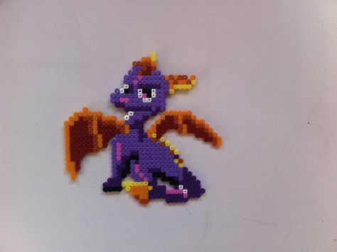 Spyro. Created from hama beads Spyro Pixel Art, Spyro Perler Beads, Perler Beads Art, Fuse Bead Ideas, Stitch Games, Bead Cross Stitch, Perler Designs, Bead Animals, Beads Perler