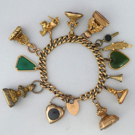 Designed and worn in the 1960's by a well-heeled South Australian lady, this antique bracelet is not your typical charm bracelet (to say the least!).

This mammoth antique charm bracelet is adorned with 19th century intaglio charms and an array of other intriguing vintage charms. Thirteen charms in total and 130+ grams in weight, the curb padlock bracelet is made of 15ct gold, hallmarked for year 1905 and stamped with Birmingham maker John Grinsell & Sons. Antique Charm Bracelet, Padlock Bracelet, Upcycled Vintage Jewelry, Cameo Bracelet, Victorian Jewellery, Vintage Jewelry Antique, Engraved Bangle, Engraved Cuff, Marcasite Jewelry