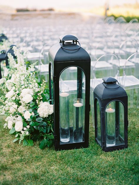 Ceremony aisle black lanterns with floating candles Black Lanterns Wedding Aisle, Garden Wedding Ceremony Aisle, Black Lantern Wedding, White Lanterns Wedding, Lantern Wedding Ceremony, Wedding Ceremony Aisle, Garden Wedding Ceremony, Ceremony Aisle, Garden Weddings Ceremony