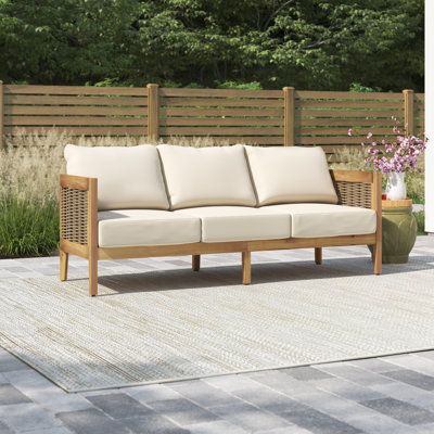 This patio sofa gives you a spot to relax on your porch or deck. It has a streamlined UV- and water-resistant solid acacia wood frame that rests on slightly tapered legs and features curved back corners for a graceful look. We love how the brown finish brings out the wood's natural grain for a coastal farmhouse feel. Breathable wicker rattan side accents and an open back complete the design. Beige-toned polyester cushions provide just the right amount of support as you enjoy casual coffee chats Patio Furniture Conversation Sets, Outdoor Patio Sofa, Sofa With Cushions, Patio Daybed, Patio Couch, Outdoor Couch, Teak Outdoor, Patio Sofa, Wooden Dining Tables