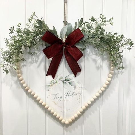 This Beautiful Heart shape Wood Bead wreath is perfect for Valentines, Mother’s Day, house warming gift, or home decor. It features greenery, lambs ear leaves, and a Red bow that stands out with the neutral color of wooden beads. Measurements: approximately 16” in Diameter Care: Excessive exposure Bead Wreaths, Wedding Door Wreaths, Wood Bead Wreath, Valentines Wreaths, Bead Wreath, Heart Shaped Wreath, Diy Valentines Day Wreath, Valentine Wreath Diy, Diy Valentine's Day Decorations