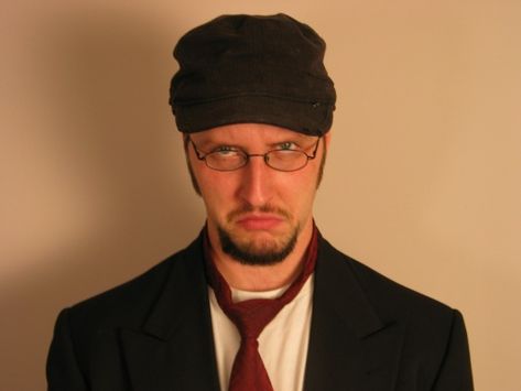 The Nostalgia Critic is a character portrayed by Douglas Darien Walker. He reviews nostalgic movies, pointing out their flaws and inconsistencies, and often gets angry in the middle of watching them. The movies he reviews have driven him to shout, babble, take cold showers, destroy DVDs and fire his (fake) gun randomly. He has declared himself to be the Angry Video Game Nerd's mortal enemy and rival. Despite the rivalry depicted in their videos, Doug Walker and James Rolfe are good friends... Nostalgia Critic, Film Critic, Worst Movies, Super Mario Bros, Best Tv, Mario Bros, One In A Million, Net Worth, Super Mario