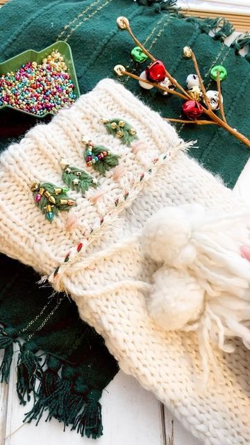 Laine Irene on Instagram: "Stockings were always my favorite thing about Christmas morning growing up 🥰 I stitched up this sweet stocking for my daughter this year and added all kinds of Christmas beads, bells and stars to it! Then added in a pretty red and green yarn and did a whipped back stitch with TINSEL yarn 🤩 So cozy for the holidays! Stocking is from @joann_stores and is perfect for adding your own touch to! . . . #stocking #christmastime #fiberart #handmadewithjoann #cozyvibes #merryandbright" Beaded Christmas Stocking, Whipped Back Stitch, Christmas Beads, Green Yarn, Diy Sweater, Christmas Bead, Holiday Magic, About Christmas, Handmade Holiday