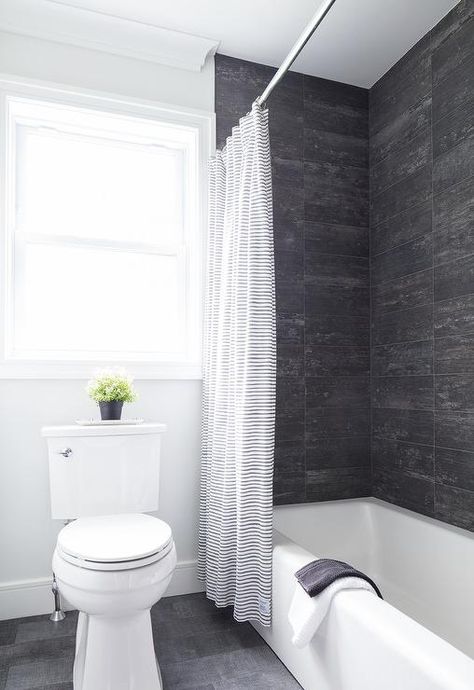 Rustic black and wood like shower wall tiles featured in a drop in bathtub fitted by a black and white striped shower curtain. Black Tile Around Bathtub, Black And White Tub Shower Combo, Black And White Bathtub, Shower Combo Ideas, Shower Wall Tiles, Bathtub Tile Surround, Tile Around Bathtub, Black Bathtub, Farmhouse Shower Curtain