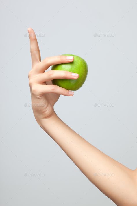 Hand holding apple. by Fisher-Photostudio. A female Caucasian hand holding a whole green apple on grey studio background.#Fisher, #Photostudio, #female, #Hand Hand Holding Apple Reference, Holding Food Reference, Holding Apple Pose, Holding Apple Reference, Hand Holding Something Reference, Hand Reference Holding Object, Hand Reference Photography, Hand Holding Apple, Apple In Hand