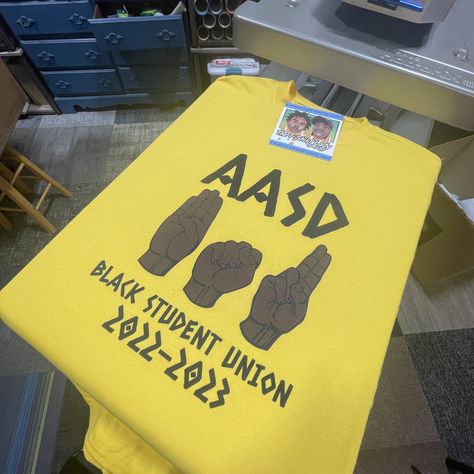 Hot Off The Press! 🙏🏽🔥 🌱 Custom T-Shirts for #AASD Black Student Union ~~~~~~~~~~~~~~~~~~~~~ #thetshirtlady #entrepreneur #familybusiness #custom #smallbusiness #tshirts #customtees #tshirtprinting #clothing #embroidery #customswag https://TheTShirtLady.com Black Student Union Shirts, Black Student Union Ideas, Bsu Ideas, Black Student Union, Clothing Embroidery, School Theme, School Themes, Custom Tees, The Press