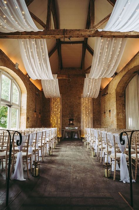 White Gold Wedding Cotswold Pictures Barn Reception Drapes Fairy Lights Decor #wedding #barnwedding Ceiling Drapery With Fairy Lights, Wedding Ceiling Draping With Lights, Ceiling Design Wedding, Fairy Lights Decor Wedding, Lights Decor Wedding, White Drapes Wedding, Tent Ceiling, Wedding November, Shed Wedding