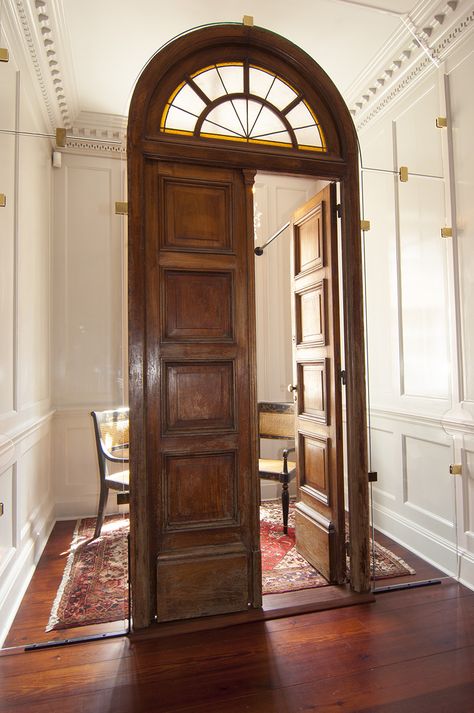 Beautiful hardwood door from Argentina set in to glass to keep the identity of the building clean.  the door forms an entrance to a quiet space with seating for two. Quiet Elegance, Apartment Entrance Door, Historical Doors, English Manor Interior, 1830 Door, Ancient Bifold Door, Stained Glass Door Vintage, Victorian Entrance, Reproduction Antique Doors