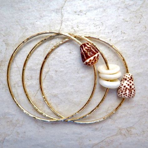 "3 Hawaiian Shell Bangles~ 3 beautiful Hawaiian shell bangles hammered and polished for that extra sparkle. Perfect gift for the beach lover! *This listing is for 3 custom made 14k gold fill 12 gauge (thick) hammered bangles with your choice of shells. If you are ordering a small or extra small bangle you may want to choose a shell from the second picture with smaller shells* **Made with 14k gold fill thick 12 gauge wire, thicker than 14 gauge.** Please view the last picture on this listing that Gold Green Necklace, Shell Bangles, Shells Craft, Hawaiian Bracelets, 2024 Wardrobe, Hammered Bracelet, Hammered Bangles, Formal Jewelry, Hawaii Style