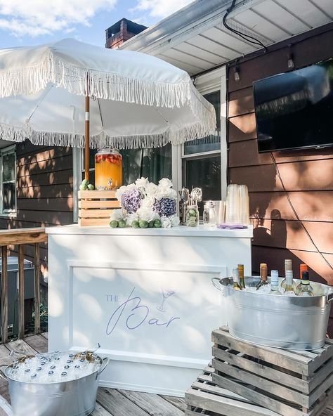 Bar styling and setup to celebrate my Mother In Law’s milestone birthday last night! 🤍 Now offering fringe umbrella rentals and bar styling with your bar rental! The perfect addition to your summer party 🤍 Cocktail Stand Ideas, Drink Cart Ideas For Party, Brand Party Events, Bar Attached To Wall, Backyard Wedding Bar Ideas, Classy Backyard Party, Self Serve Drink Station Wedding, Engagement Party Bar Cart, Bar Setup For Party