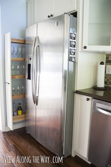 Clever, narrow, sliding out to side of fridge. I probably wouldn't use it for glassware / liquor (I prefer glassware by the sink or bar area & the fridge may emit heat that damages beverages) like the photo but it could be a great spot for other items. Wine Glass Cabinet, Tall Narrow Storage, Narrow Cabinet Kitchen, Side Of Fridge, Tall Narrow Storage Cabinet, Alcohol Storage, Narrow Storage, Narrow Storage Cabinet, Refrigerator Cabinet