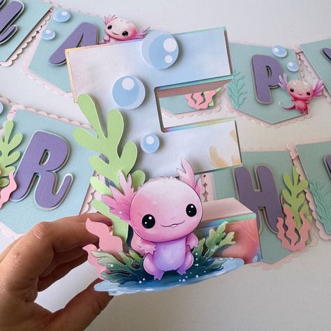 Beautiful Axolotl 3D letter. Perfect to decorate your table with the initial of the birthday child. Bring all the magic to your Axolotl Party or event.  DETAILS: *This listing is for 1 3d letter. If you need more than one please select it in quantity.  *This 3d letter is made in high quality CARDSTOCK PAPER (65-80LB)  *The size of the 3D letter is 8"  *All the images and details are placed on the letter with foam tape to give it a 3D look.  *There are two different designs on the pictures. Pleas Axolotl Party Decorations, Axolotl Birthday Party Decorations, Axolotl Birthday Party Ideas, Axolotl Party Ideas, Axolotl Birthday Party, Axolotl Party, Wooden Letter Ideas, Birthday Treat Bags, Ocean Party