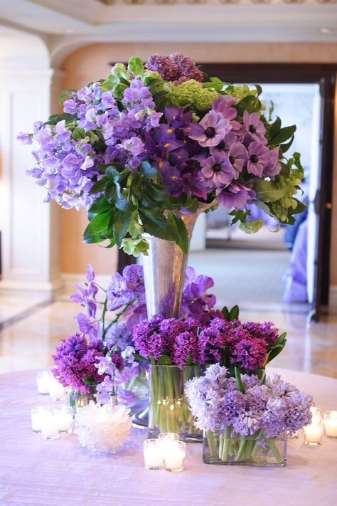 AN entry table to a Bat Mitzvah, full of different types of flowers in shades of purple and lavender including anemones, sweet peas, and hyacinth. Designed by KD&J Botanica. Photo by Neil Landino. #purpleflowers #anemone #sweetpea Hotel Flower Arrangements, Purple Flower Arrangements, Westport Connecticut, Hotel Flowers, Luxury Flower Bouquets, Purple Wedding Theme, Floral Design Studio, Flower Vase Arrangements, Memorial Flowers