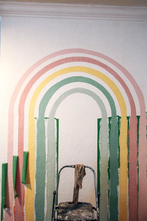 how to paint a rainbow mural on the wall. This easy tutorial makes the cutest pastel DIY mural. This would be perfect in a bedroom, kids room, nursery, classroom, or bathroom. A simple 70s painting Boho Rainbow Paint Colors, Classroom Painting Ideas Walls, Pandora Room, Easy Murals To Paint, Feng Shui Water Element, 70s Painting, Painting A Rainbow, Rainbow Wall Mural, Rainbow Mural