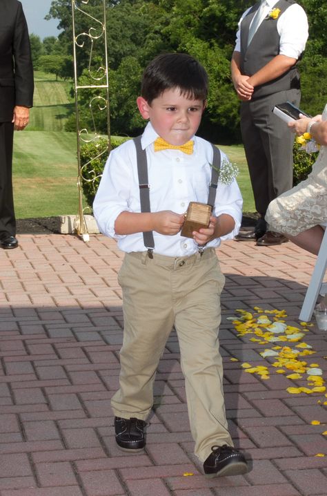 Yellow and gray wedding.  Outdoor summer wedding. Ring bearer outfit in khakis, gray suspenders, yellow and gray bow tie.  Ring bearer ring box. Ring bearer boutonniere. Ring Bearer Outfit Khaki Pants, Ring Bearer Boutonniere, Wedding Ring Bearer Outfit, Bow Tie Ring, Grey Suspenders, Tie Ring, Grey Bow Tie, Bearer Outfit, Ring Bearer Outfit