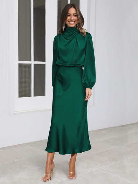 Make a statement in this FROM THE SOURCE High Neck Bridal Maxi Dress in an elegant emerald! This stunning satin dress will make waves as you walk down the aisle and beyond. Dare to be bold and defy expectations with this daring wedding guest style dress. Stand out! Size Guide: Model is 5’7” tall, and has a 33.4” bust, 26.5” waist, & 34.6” hips. She is wearing a S / US 4 / AU 8. This dress is true to size. Material: 100% Polyester. Feature: High Neckline. Long Sleeve. Flowery Skirt. Elastic Waist. Maxi Length. Care Instructions: Machine wash / Cold hand wash Outfit Boda, Bridal Maxi Dress, Long Sleeve Satin Dress, Satin Dresses Long Sleeve, Wedding Guest Style, Satin Long Sleeve, Elegant Maxi Dress, Dress Stand, Satin Midi Dress