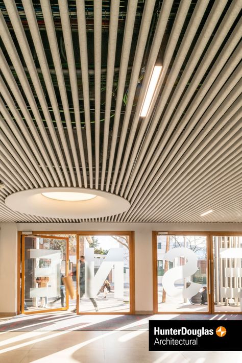 HeartFelt® Ceiling in Madrid, Spain Wood Ceiling Panels, Baffle Ceiling, Douglas Wood, Innovation And Technology, Open Ceiling, School Entrance, Entrance Lobby, Ceiling System, University School