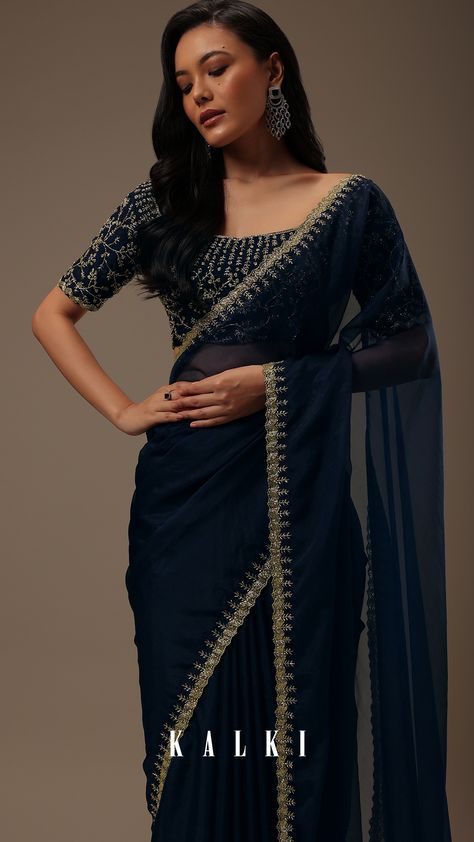 "Introducing our enchanting dark blue plain organza saree, a celebration of simplicity and opulent detailing. 
This saree showcases a cutdana border that adds a touch of elegance. The unstitched blouse fabric features heavy cutdana work all over.
EVENT - Perfect for evening parties.
The saree comes with a matching unstitched blouse." Dark Color Sarees Party Wear, Navy Blue Saree Party Wear, Dark Colour Saree For Farewell, Heavy Blouse With Plain Saree, Dark Blue Saree For Farewell, Dark Blue Blouse Designs, Dark Color Saree, Simple Elegant Saree, Dark Saree