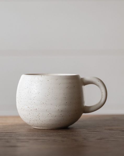 The rounded design with ribbed pattern are ideal for wrapping a hand around its base in warm comfort. Purchase multiples and share one with a friend to enjoy a special time of aromatic hot drinks along with stimulating conversation. 4-1/2" Round x 3-1/2"H 16 oz. Stoneware Mug, Reactive Glaze, Beige Speckled (Each One Will Vary) Goes with everything, feels earthy and adds a bit of texture. Round Mug, Ceramic Mugs Designs Creative, Cafe Mugs, Pottery Room, Matcha Kit, Vintage Inspired Bedroom, Handmade Mugs, Modern Mugs, Matcha Bowl