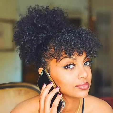 curly bangs on black women Twist With Bangs For Black Women, Afro Puff With Bangs, Crochet Bangs Hairstyles, Curly Hair Bangs Black Women, Black Curly Hair Bangs, Natural Hair Bangs Black Women, Curly Bun And Bangs, Curly Hair With Short Bangs, 4c Bangs