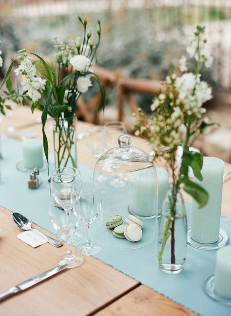 Make the color blue the focal point of your tablescape by playing up a robin's egg blue runner. Paired down cluster arrangements, translucent cloches, and monochrome candles—like the scene set here, by By Mademoiselle C and Elmo Paperstories Ltd.—are the only décor elements you need. Robin Egg Blue Wedding, Aqua Bridesmaid Dresses, Blue Taper Candles, Vintage Shabby Chic Wedding, Chic Wedding Style, Shabby Chic Wedding Decor, Aqua Wedding, Robin Egg Blue, Estilo Shabby Chic