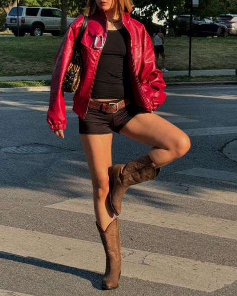 red jacket, bold attitude 🚨 @aelfricedenofficial #streetgirl #fallinspo #fallfashion #fallvibes #falloutfits #pinterestoutfit #chicoutfit #aesthetics #fashionstyle red leather jacket, black mini shorts, short hair, cowboy boots, leopard print, leopard handbag, fall jacket, fall boots, fall outfit ideas, cheetah print bag, vintage belt, thrift finds Red Cowboy Boot Outfits, Red Leather Shorts Outfit, Shorts With Cowboy Boots, Micro Shorts Outfit, Shorts Cowboy Boots, Mini Shorts Outfit, Red Leather Jacket Outfit, Black Mini Shorts, Cheetah Print Bag