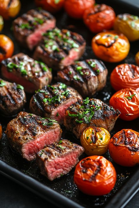 Grilled steak cubes and roasted cherry tomatoes on a black tray. Indoor Griddle Recipes, Recipes For Blackstone Grill, Ribs On Blackstone Griddle, Hibachi On Blackstone Griddle, Blackstone Dinner Recipes, Healthy Blackstone Recipes, Blackstone Griddle Recipes Dinners, Blackstone Dinner Ideas, Blackstone Dinner