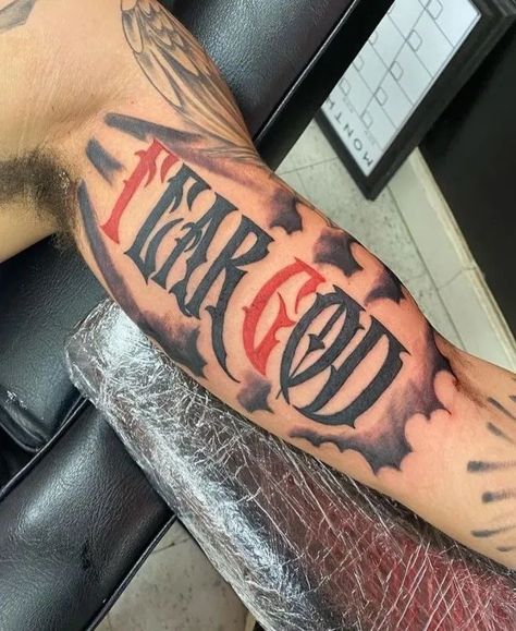 Black God Tattoos For Men, Fear God Inner Bicep Tattoo, Tattoo Ideas For Men Fear God, Fear None Tattoo Men Hand, Red Tattoo Men Ideas, Best Back Tattoos Men Design, Fear No One Tattoo Men, Fear God Bicep Tattoo, Red And Black Tattoos Men