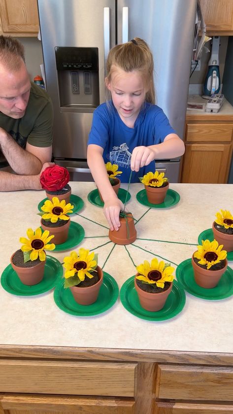 Don't pull the Wrong Flower 😂 | flower, entertainment, flowerpot | Don't pull the Wrong Flower 😂 Kids and family play fun spring table game with flower pots. Great outdoor game for spring. This video was produced by... | By Wonder and Raw | Facebook | Pull one. Pull one. Oh it's this one. This one right here. I'm sorry. Let's see. Let's see. There you go. Oh $10. Nice. $10. Nice. Your turn Kess. Pull a string. Pull one string. Oh it's that one. What it is? What is inside? What's inside? What c Reverse Raffle, Connect Group, Twister Game, Fest Ideas, Concentration Games, Flower Birthday Party, Flower Games, Plant Games, 6 Birthday