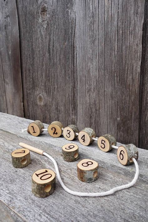 This wooden lacing toy is made from 10 natural tree slices. Each one of them is sanded and covered with a natural/child safe linseed oil.  Size of tree slices: - diameter: 2,5cm - 3 ,5cm - width: 2cm  Because this toy is made from natural branches, each set may differ from one another. And a few cracks or flaws in slices are acceptable, as they occur in the drying process. Math Montessori, Lacing Toy, Montessori Practical Life, Montessori Math, Wooden Numbers, Homemade Toys, Toddler Gift, Natural Toys, Waldorf Toys