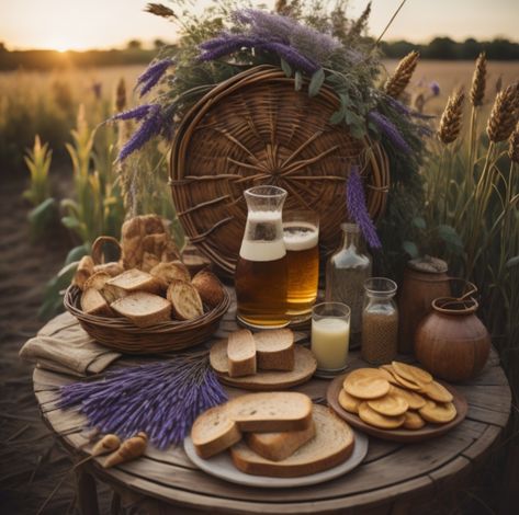 A feast of bread, mead, and lavender sprigs on a table in front of a woven wheel standing in a wheat field. Lammas Lughnasadh Aesthetic, Lughnasadh Celebration, Lughnasadh Aesthetic, Lughnasadh Ritual, Lughnasadh Altar, Lammas Altar, Lammas Lughnasadh, Pagan Calendar, Beltane