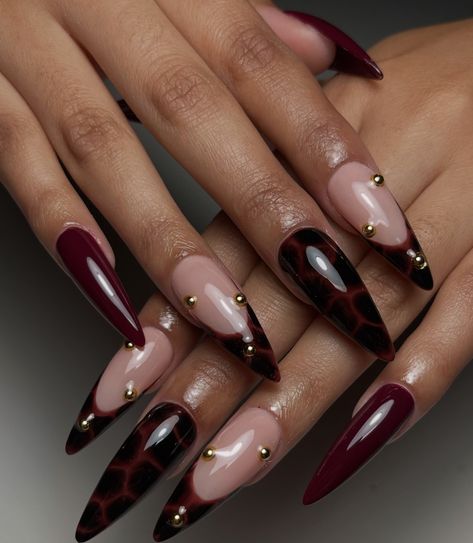 Burgundy And Cheetah Nails, Dark Red Nails With Charms, Dark Feminine Aesthetic Nails, Red Nails Butterfly, Dark Acrylic Nails Designs, Maroon Nail Designs Burgundy, Red Tortoise Shell Nails, Red And Black Almond Nails, Black Nye Nails