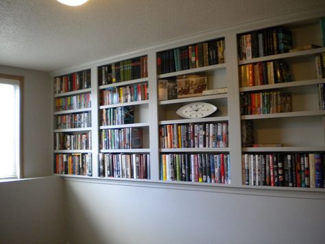 My Bookshelves are done! Entire wall above the ledge in lower level spare bedroom can now hold books. Thank you to SOS Carpentry in Fargo, ND! Half Wall Library Shelves, Built In Shelves Living Room Half Wall, Half Wall Shelves Built Ins, Wall Ledge In Bedroom, Ledge Wall Basement, Basement With Ledge Half Walls Decor, Rooms With Ledges All Around, Half Shelf Wall, Basement Half Wall Ledge Shelves